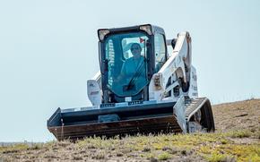 A U.S. military employee uses a Bobcat skid steer at the Vaziani Training Area near Tbilisi, Georgia, in 2023. Army Capt Jacob Suenkel, 32, pleaded guilty in federal court to selling a Bobcat, a tractor and other equipment he stole from units at Fort Stewart, Ga.