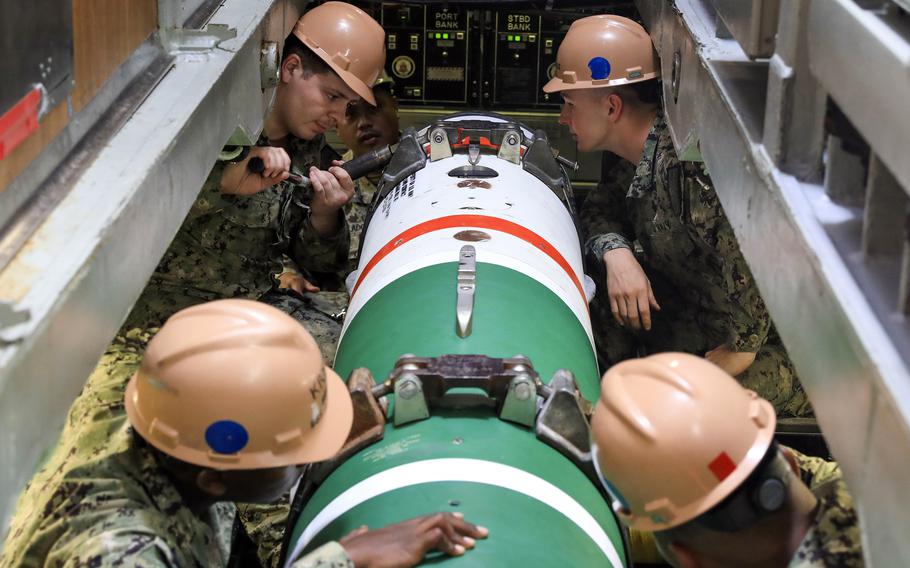 Sailors load a submarine-launched mobile mine aboard the USS Annapolis, May 4, 2022.