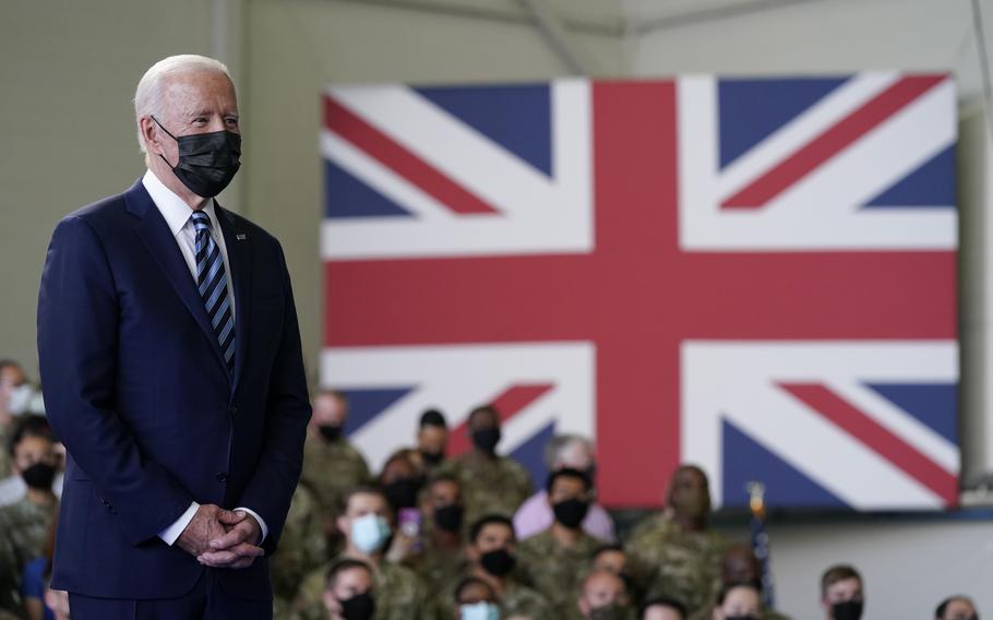 President Joe Biden listens as first lady Jill Biden speaks to American service members at RAF Mildenhall in Suffolk, England, on June 9, 2021.