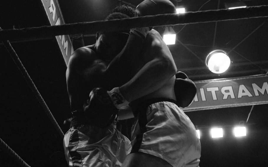 Ali and Mildenberger tangled in a clinch in the corner of the ring.