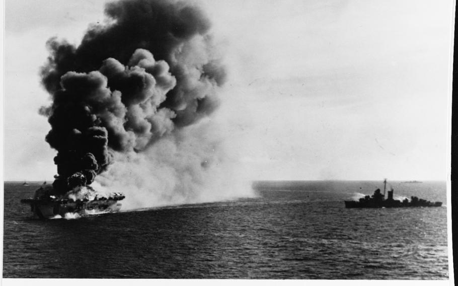 The USS Ommaney Bay exploding after being hit by a Kamikaze attack in the Sulu Sea off the coast of the Philippines in 1945. Two destroyers are standing by.