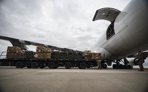 Airmen from the 436th Aerial Port Squadron load cargo during a security assistance mission at Dover Air Force Base, Delaware, Jan. 13, 2023. The United States has committed more than $24.5 billion in security assistance to Ukraine since the beginning of Russian aggression. (U.S. Air Force photo by Staff Sgt. Marco A. Gomez)