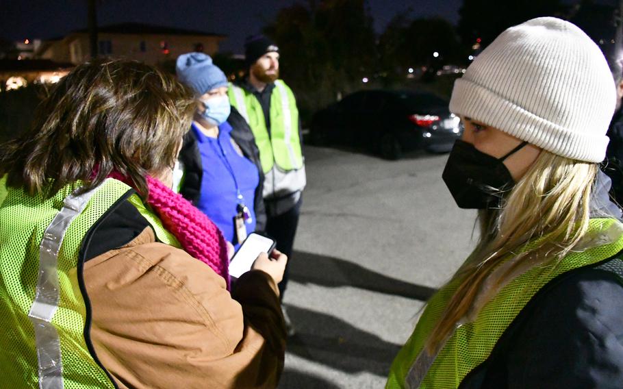 Department of Veterans Affairs employees gather Wednesday, Feb. 23, 2022, to count homeless veterans on the VA West Los Angeles campus. They logged the veterans in a mobile app, and the numbers were automatically shared with the Los Angeles Homeless Services Authority.