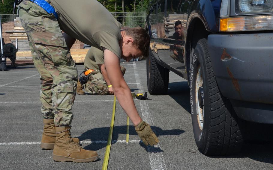 Members of Team PDLC take measurements to calculate the center of balance of a vehicle during the 721st Aerial Port Squadron Multi-Capable Airmen Rodeo at Ramstein Air Base, July 23, 2021.