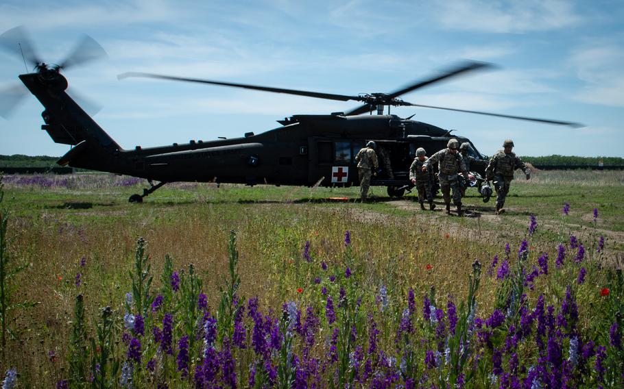 Soldiers carry Brig. Gen. Clinton Murray from a UH-60 Black Hawk helicopter to a medical field hospital near Bordusani, Romania, on June 6, 2023, during Exercise Saber Guardian.