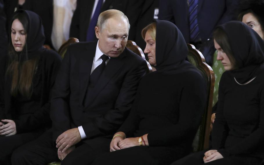 Russian President Vladimir Putin talks to Yelena Baturina, widow of former mayor of Moscow Yuri Luzhkov, during a farewell ceremony at the Cathedral of Christ the Saviour in Moscow, Russia, on Dec. 12, 2019. 