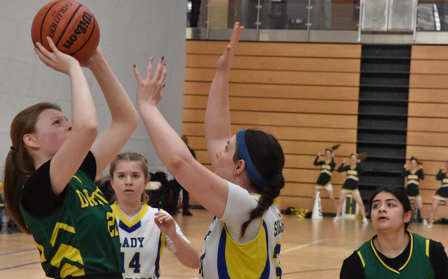 Alconbury’s Elizabeth Schroeder shoots over Sigonella’s Laney Reardon on Thursday, Feb. 15, 2024, at the DODEA European Division III Basketball Championships in Wiesbaden, Germany.