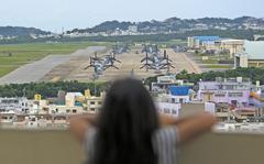 A child looks out at aircraft at Marine Corps Air Station Futenma, Okinawa, April 19, 2019.