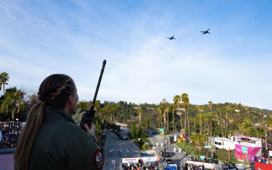 U.S. Air Force Capt. Sarah Brandt uses a land mobile radio to communicate with the crew of two B-1B Lancers from the 7th Bomb Wing, Dyess AFB, Texas, Jan. 2, 2023. The B-1s conducted a flyover for the 109th Rose Bowl Game.