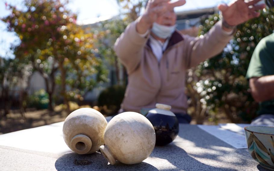 Late in World War II, with iron supplies running low, Japan’s military ordered potters to make grenades. Locals turned the old casings into flower holders and garden ornaments, according to Sadao Tokita, 83, who keeps half a dozen in his backyard.