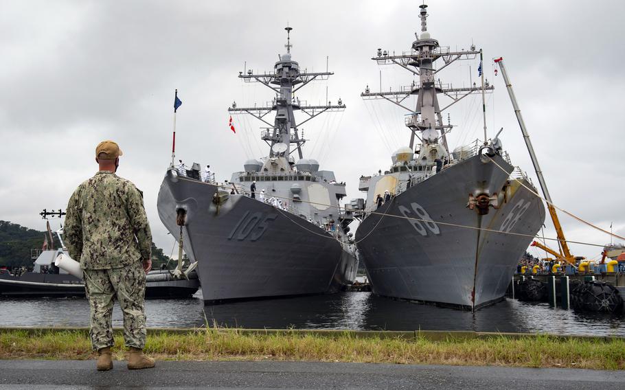 Yokosuka Command Master Chief Robert Beachy watches as the guided-missile destroyer USS Dewey, left, moors alongside USS The Sullivans at Yokosuka Naval Base, Japan Wednesday, Sept. 8, 2021. 