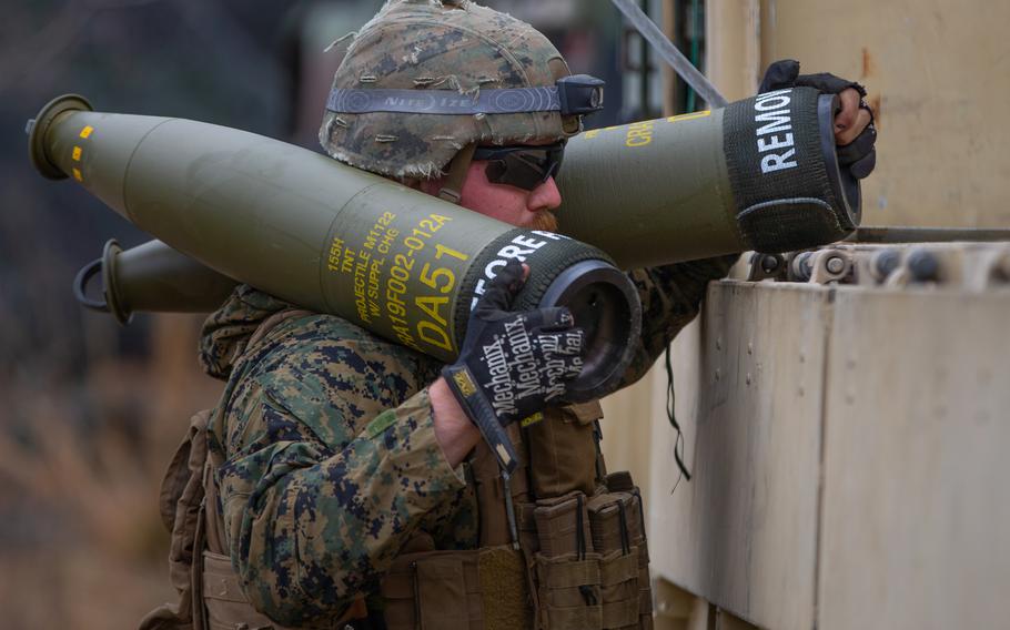 A Marine with Echo Battery, 2d Battalion, 10th Marine Regiment, 2d Marine Division, carries 155mm artillery shells during Exercise Rolling Thunder 22-2 at Fort Bragg, N.C., March 30, 2022. 