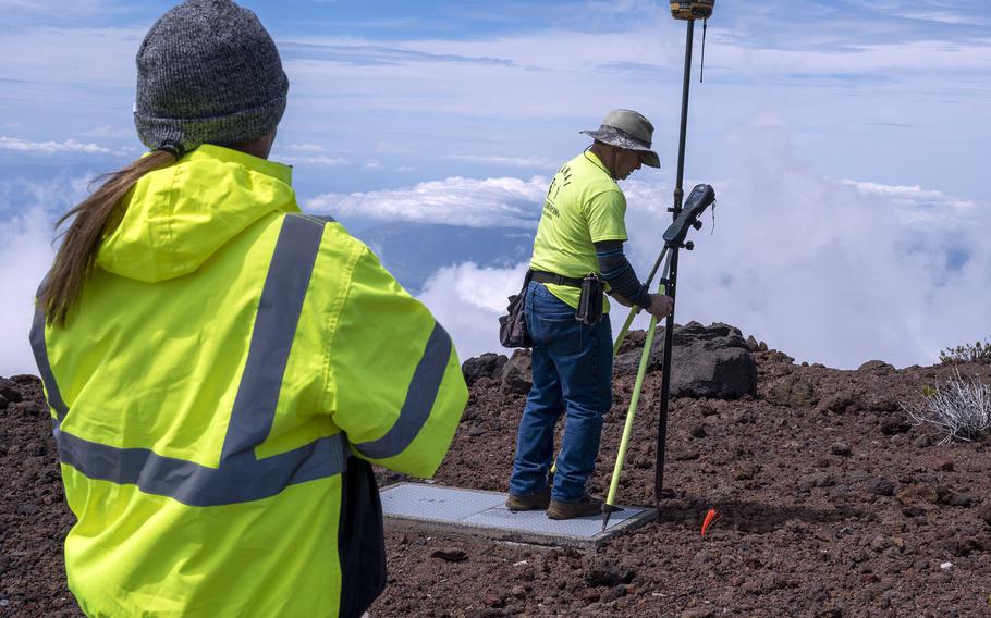 Contractors take topographical measurements prior to testing and excavating contaminated soil at the Maui Space Surveillance Complex site on the island of Maui, Hawaii, Feb. 21, 2023.