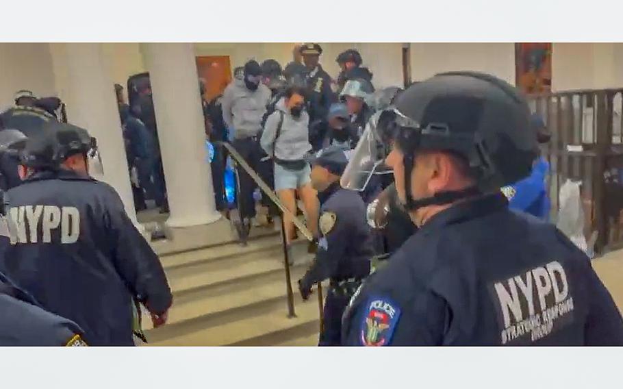A video screen grab shows members of the New York Police Department clearing out spaces at Columbia University that had been taken over by protesters.