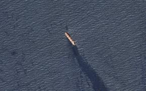 In this satellite image provided by Planet Labs, the Belize-flagged bulk carrier Rubymar is seen in the southern Red Sea near the Bay el-Mandeb Strait leaking oil after an attack by Yemen's Houthi rebels on Feb. 20, 2024.