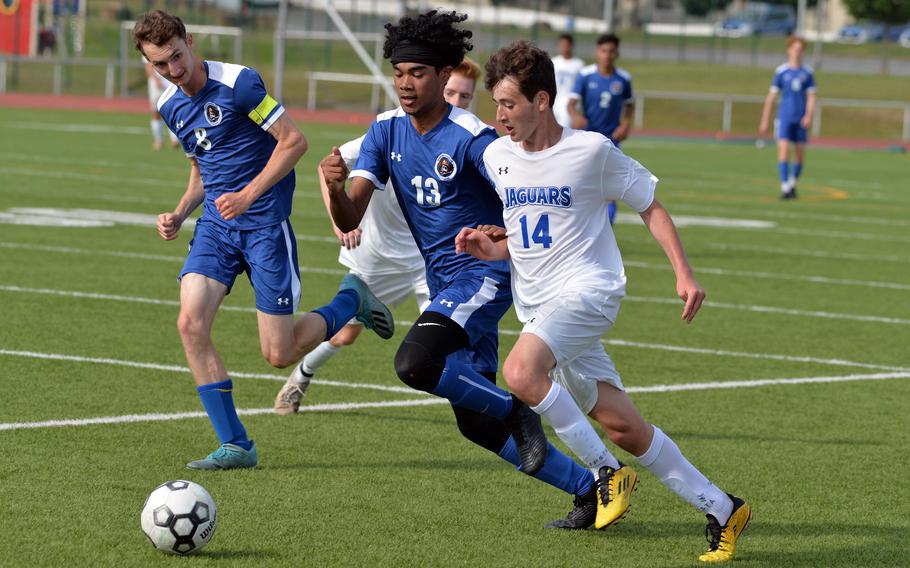 Sigonella’s Gabriell Naselli, right, takes the ball upfield against Jabriel Wells of Brussels in the boys Division III final at the DODEA-Europe soccer championships in Kaiserslautern, Germany, Thursday, May 19, 2022. The Jaguars won 5-0 to take the title. Nathan Pierce follows the action at left.