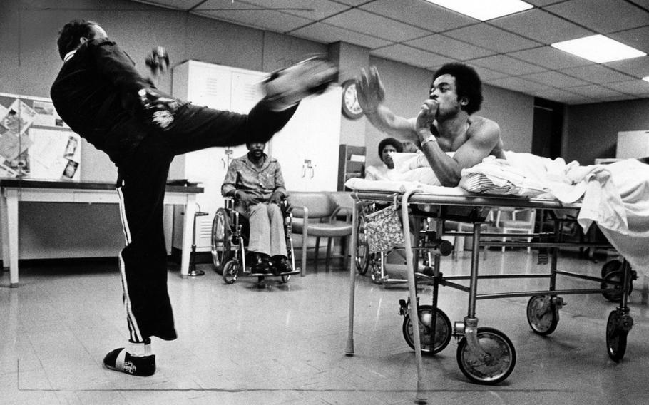 Leonard Cole, who was wounded in Vietnam in 1968, practices martial arts with instructor Jim Garrett in an experimental program that teaches tae kwon do to patients who are permanently paralyzed, circa Oct. 21, 1981. Garrett hoped participants would gain self-confidence and a better self-image through the instruction, which was modified to concentrate on upper-body movements.