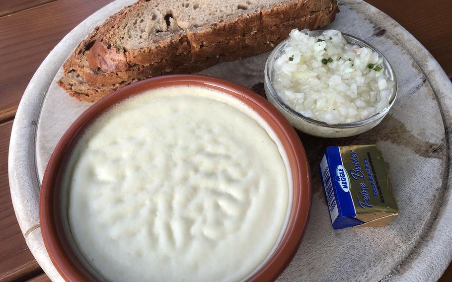 Homemade kochkaese with mussigg, as served at the Biergarten in Darmstadt , Germany. The first word in the name translates as “cooked cheese.” Served cold, the dish is made by cooking quark and butter with baking soda. Mussigg, slang for “music,” is a dressing made of oil, vinegar and chopped onion that is served over the cheese. 