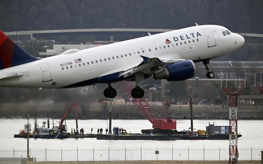 A passenger jet taking off over a river.