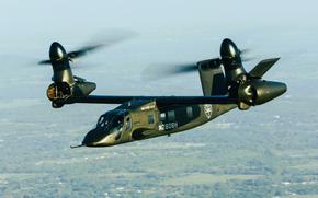 The tilto-rotor aircraft flies high.