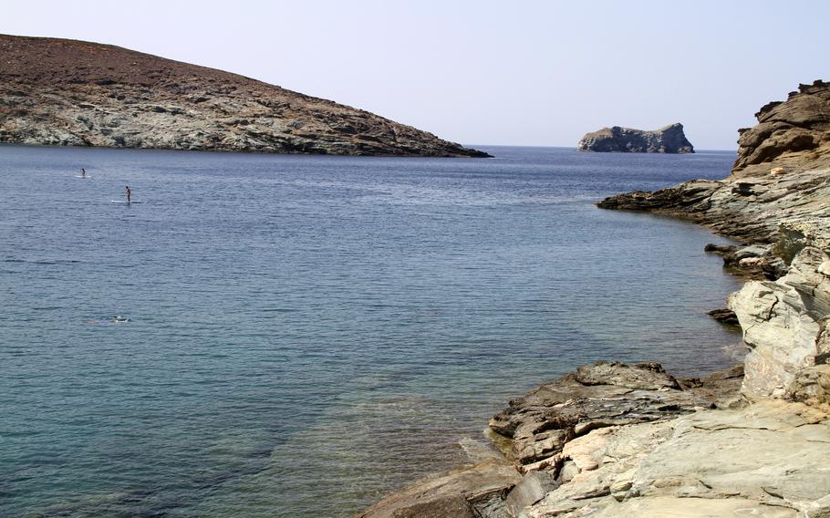 Paddleboarders enjoy the sparkling Aegean Sea off Kolimbithra beach in the island of Tinos, Greece, on Aug.27, 2021. As travel restrictions have eased since the peak of the pandemic, the Greek islands’ wide-open blue beckons. 