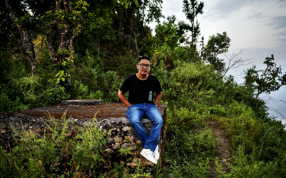 Dilip Gurung, a 32-year-old warehouse specialist from Nepal, worked for KRH, a subcontractor for Amentum in Qatar. He poses for a portrait in Danda Gaon, Tanhun District, Nepal, on Oct. 26, 2022.