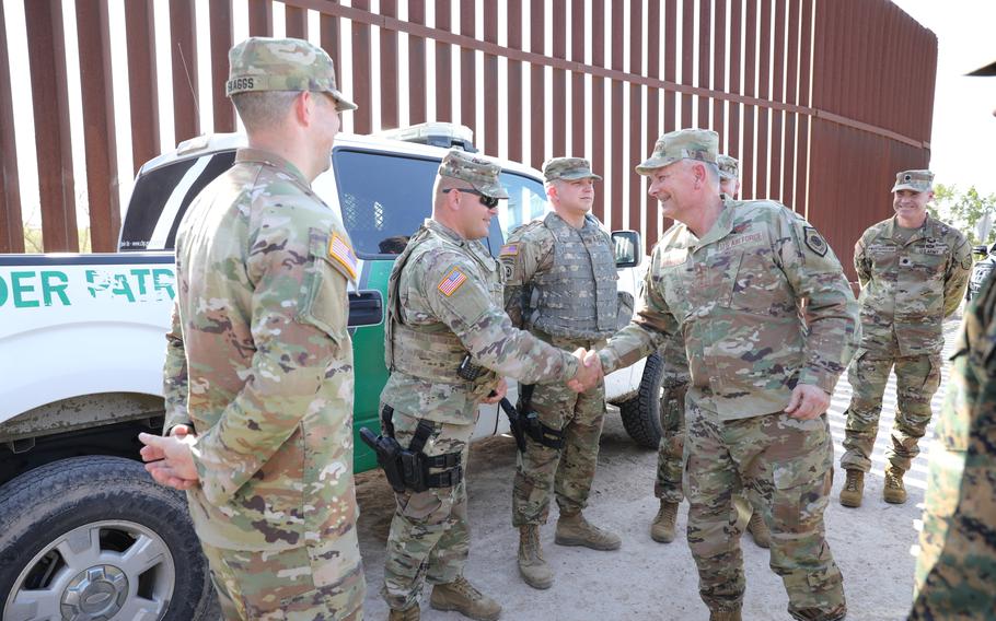 Air Force Gen. Glen VanHerck, commander of North American Aerospace Defense Command and U.S. Northern Command, presents a challenge coin Feb. 7, 2022, to Sgt. David Ewald of the Missouri National Guard’s 3175th Chemical Company during his deployment to McAllen, Texas. NORTHCOM is providing mobile surveillance camera operators, intelligence analysts, and aviation support operations to the Department of Homeland Security and U.S. Customs and Border Protection to help secure the southern border of the United States.