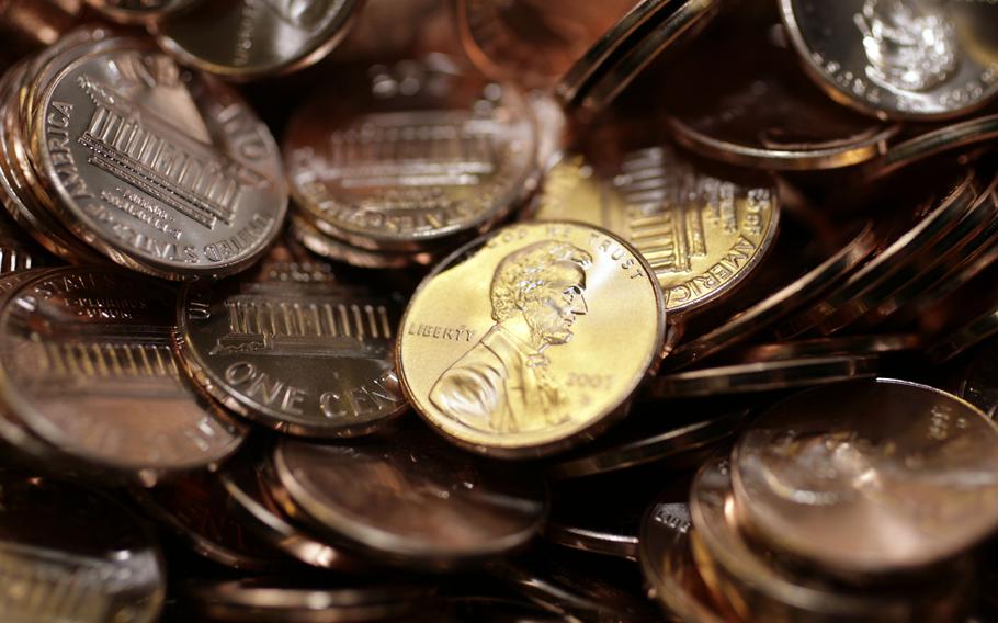 A close-up view of pennies, most of them seen from the back and one in the middle displaying Abraham Lincoln’s head.