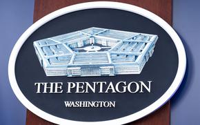 The Department of Defense logo is seen on a wall.