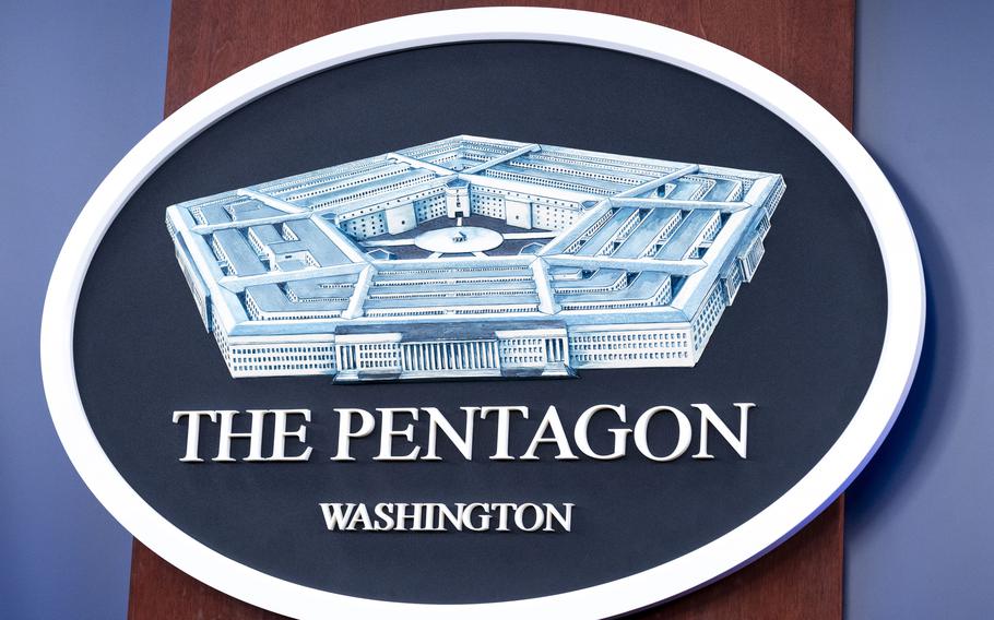 The Department of Defense logo is seen on a wall.