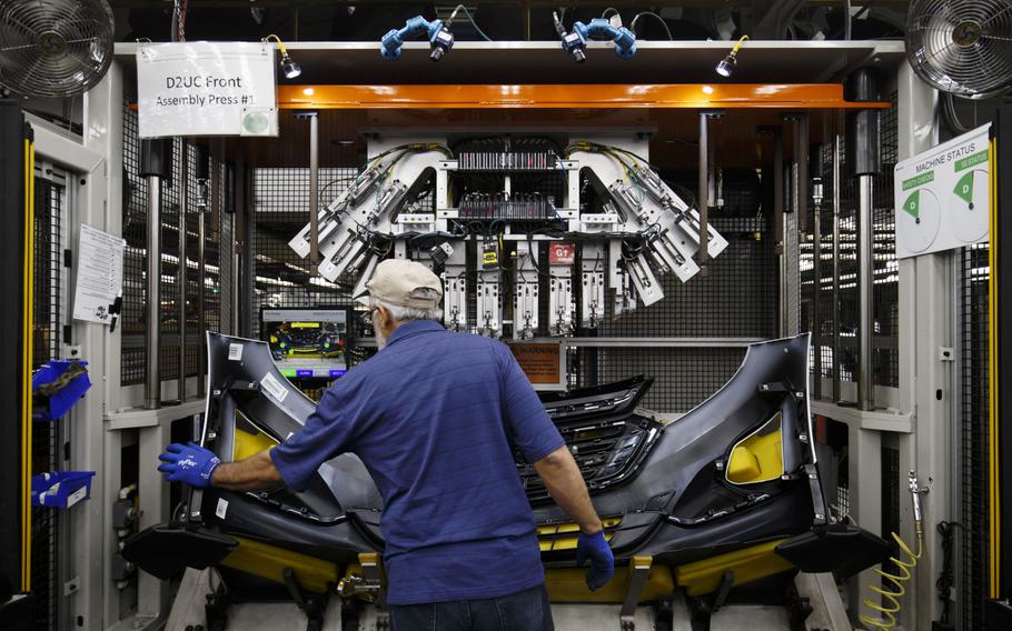 An employee assembles a bumper at an auto-parts plant in Guelph, Ontario, in August 2018.