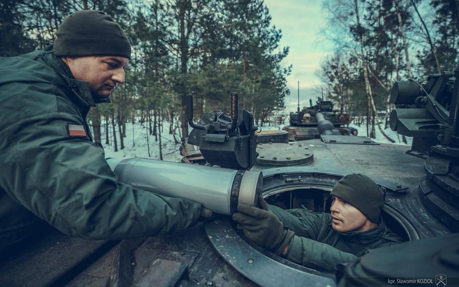 Polish soldiers load rounds onto an Abrams tank Jan. 16, 2024, during crew gunnery qualifications at Nowa Deba Training Area, Poland. The tank crew, which is taking part in live-fire drills this week, became the first in the Polish military to qualify on a U.S. Abrams tank.