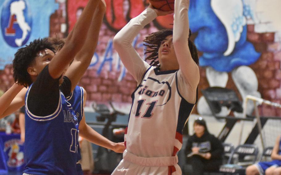 Aviano's Sergio Melendez puts up a shot before Rota's Anthony Ross can close on him in the Saints' 51-40 victory over the Admirals on Friday, Dec. 9, 2022, in Aviano, Italy.