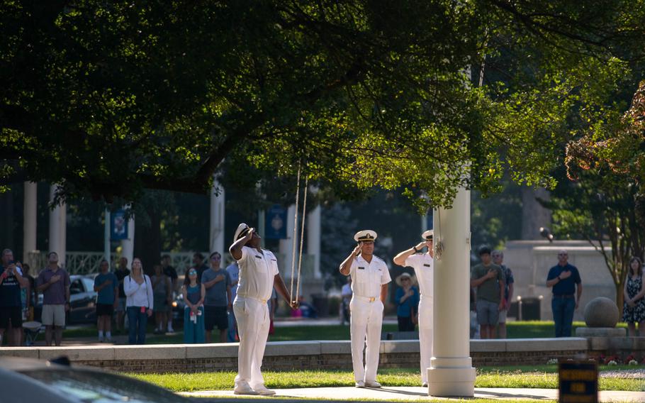 U.S Navy members and Naval Academy visitors salute during morning colors at Induction Day 2022, Thursday, June 30, 2022, at the U.S. Naval Academy in Annapolis, Md. I-Day marks the beginning of a demanding six-week indoctrination period called Plebe Summer, intended to transition the candidates from civilian to military life.