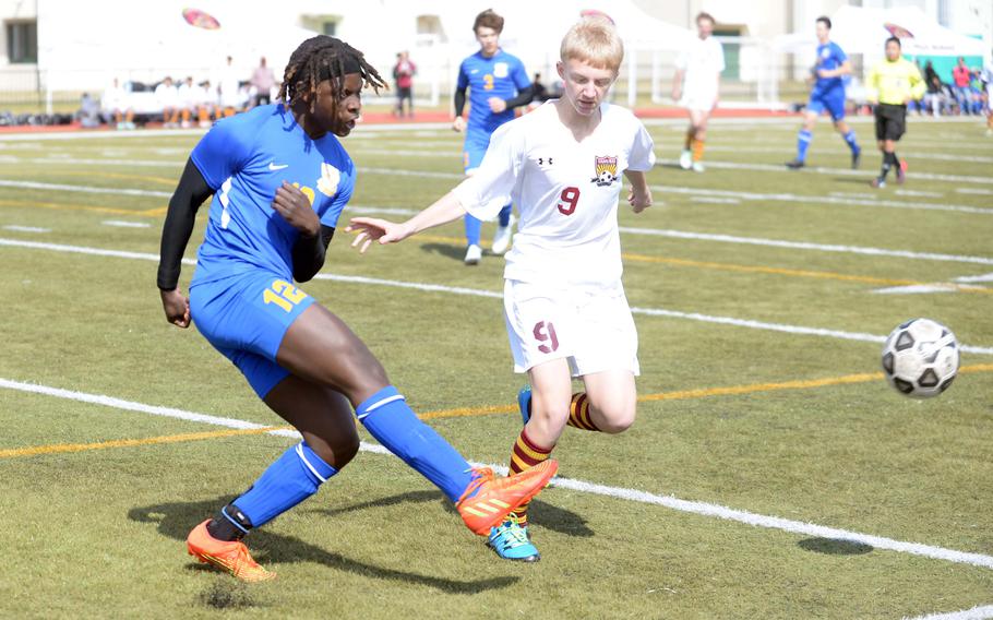 Yokota's Jai Bailey kicks the ball past Matthew C. Perry's Jalen Cooley during Friday's Perry Cup boys soccer match. The Panthers won 2-1.