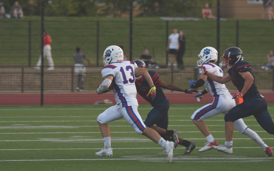 Ramstein Royals running back Landon Torroll takes a hand off and shoots to the outside, avoiding the Lakenheath Lancers' defensive line.
