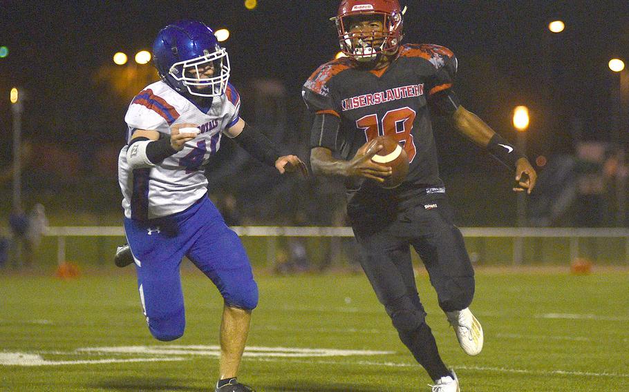 Raider quarterback Rueben Todman looks downfield as he scrambles during a game against Ramstein on Sept. 15, 2023, at Babers Stadium in Kaiserslautern, Germany. Royal defender Kydan Echard chases Todman on the play.