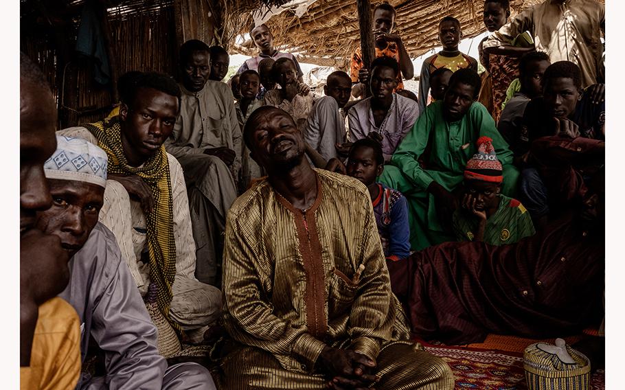 On Koulfoua island, in Chad, Hassan Mbodou, 50, front right, said his brother joined a militant because of desperation after losing cattle and struggling to catch fish.