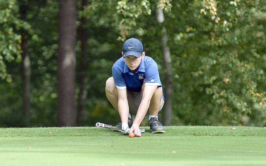 Ramstein junior Christian McHugh eyes up his putt on the 13th hole at Woodlawn Golf Course during the second round of the DODEA European golf championships on Oct. 13, 2023, on Ramstein Air Base, Germany. McHugh rallied to win the boys individual crown, while the Royals won their third straight team title.