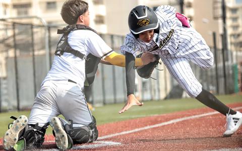 Humphreys catcher Bradley Miller tags out Kadena's Kai Redden.