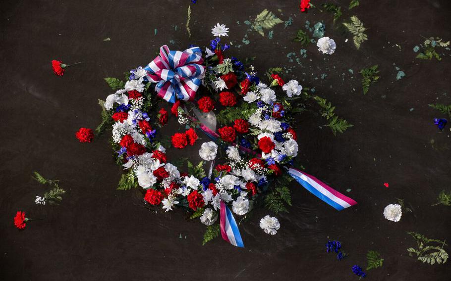 A memorial wreath floats in the Delaware River after being tossed there by Bernie Kofoet, a member of the American Legion FW Grigg Post #68, and Camden Commissioner Melinda Kane as part of a Pearl Harbor Day Commemoration.