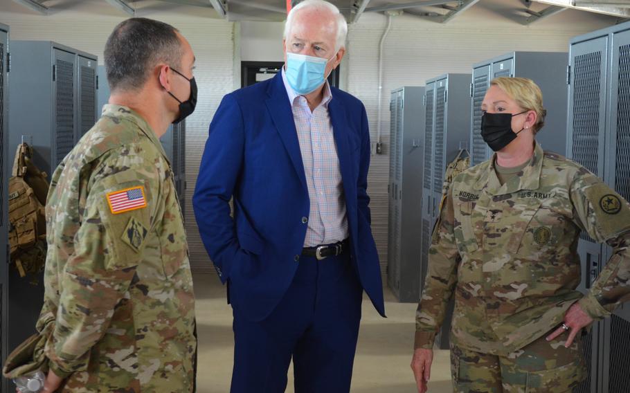 Sen. John Cornyn speaks Monday with leadership of the Texas Military Department about a new barracks at Camp Swift, Texas, that was built using 3D printing construction.