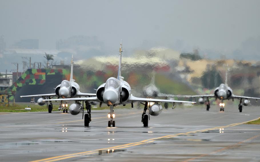 four fighter jet planes on a runway