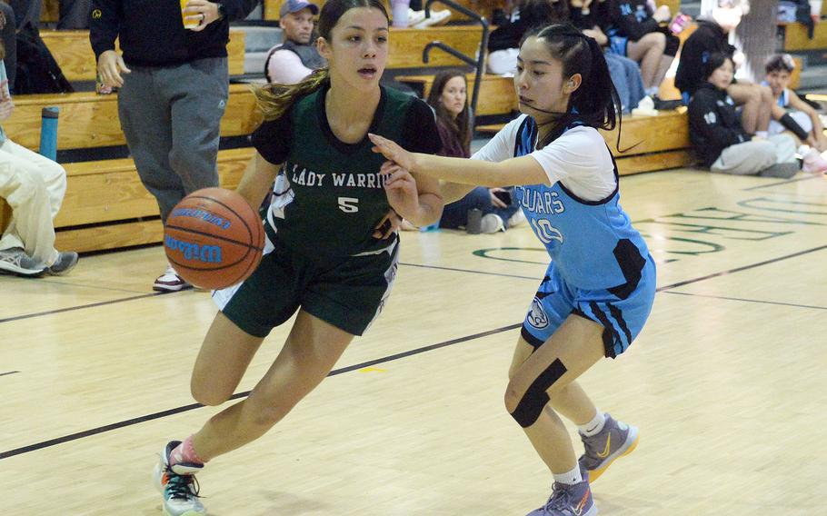 Daegu's Trinity Harvey drives against Osan's Jonessa Jones during Saturday's Korea girls basketball game. The Warriors won 52-32.