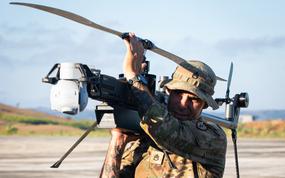 A soldier prepares a drone for takeoff.