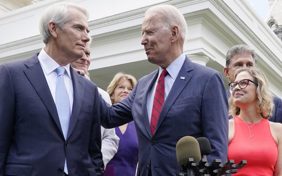 President Joe Biden speaks with Sen. Rob Portman, R-Ohio, on Thursday June 24, 2021, outside the White House in Washington. 