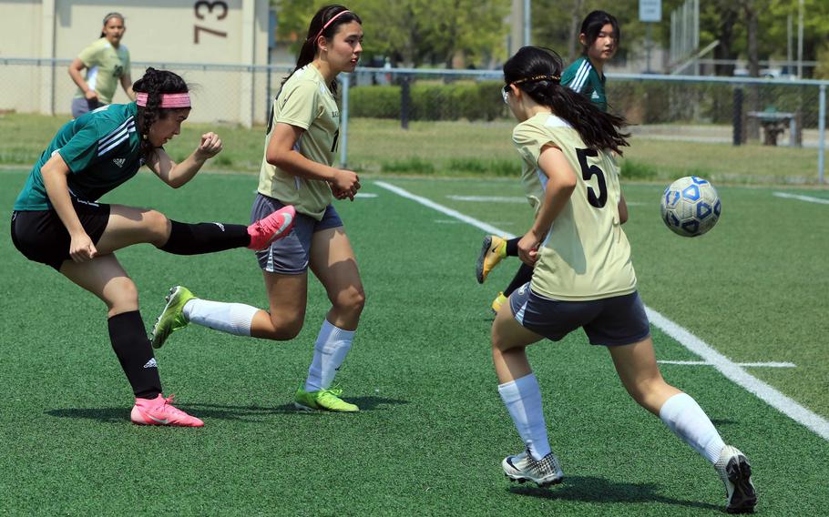 Daegu's Jaela Sahagun boots the ball between Humphreys' Hannah Clites and Kayla Collins during Tuesday's DODEA-Korea soccer match. The Warriors won 1-0.