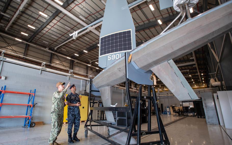 Vice Adm. Brad Cooper, commander of U.S. Naval Forces Central Command, U.S. 5th Fleet, left, and Col. Hisham Khaleel Aljarrah, commander of the Royal Jordanian navy, examine Task Force 59’s new Saildrone Explorer unmanned surface vessel at Naval Support Activity Bahrain on Nov. 18, 2021.