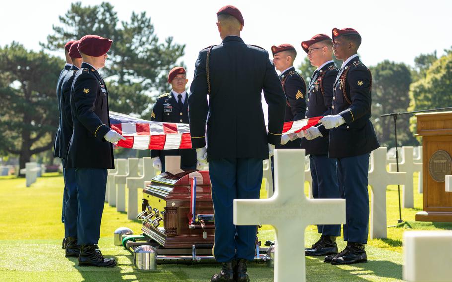 Soldiers from the 173rd Infantry Brigade Combat Team fold the American flag during a burial ceremony for U.S. Army Air Forces 2nd Lt. William J. McGowan at Normandy American Cemetery, France, on July 9, 2022.