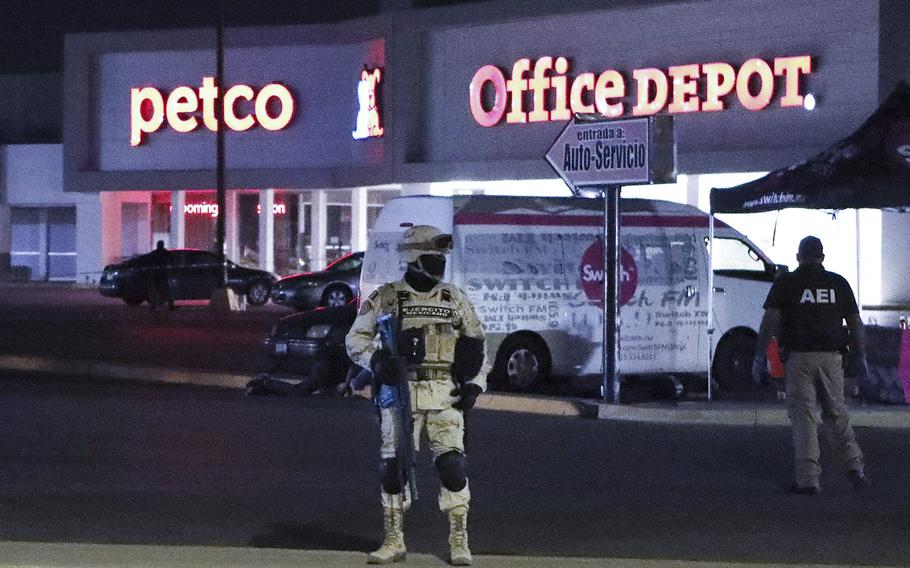 Members of the Mexican Army and forensic experts work at the site where four radio station workers were killed and two restaurant employees were wounded in Ciudad Juarez, Mexico, on Aug. 11, 2022. 